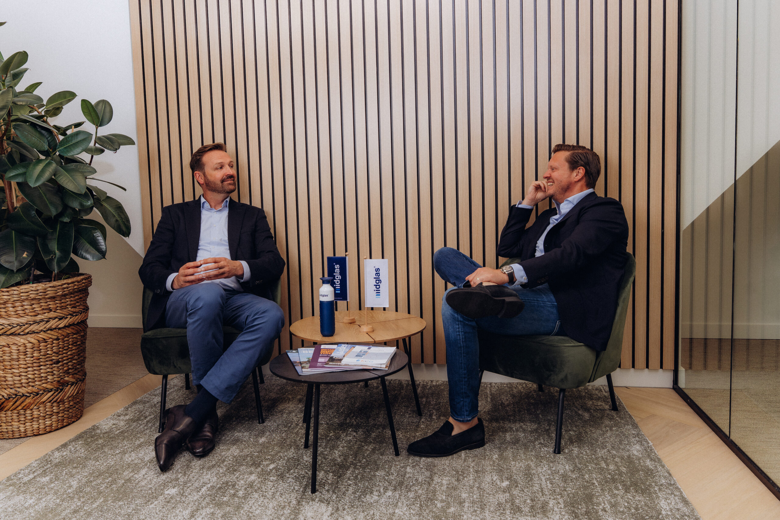 Lachende collega's op het kantoor van Midglas